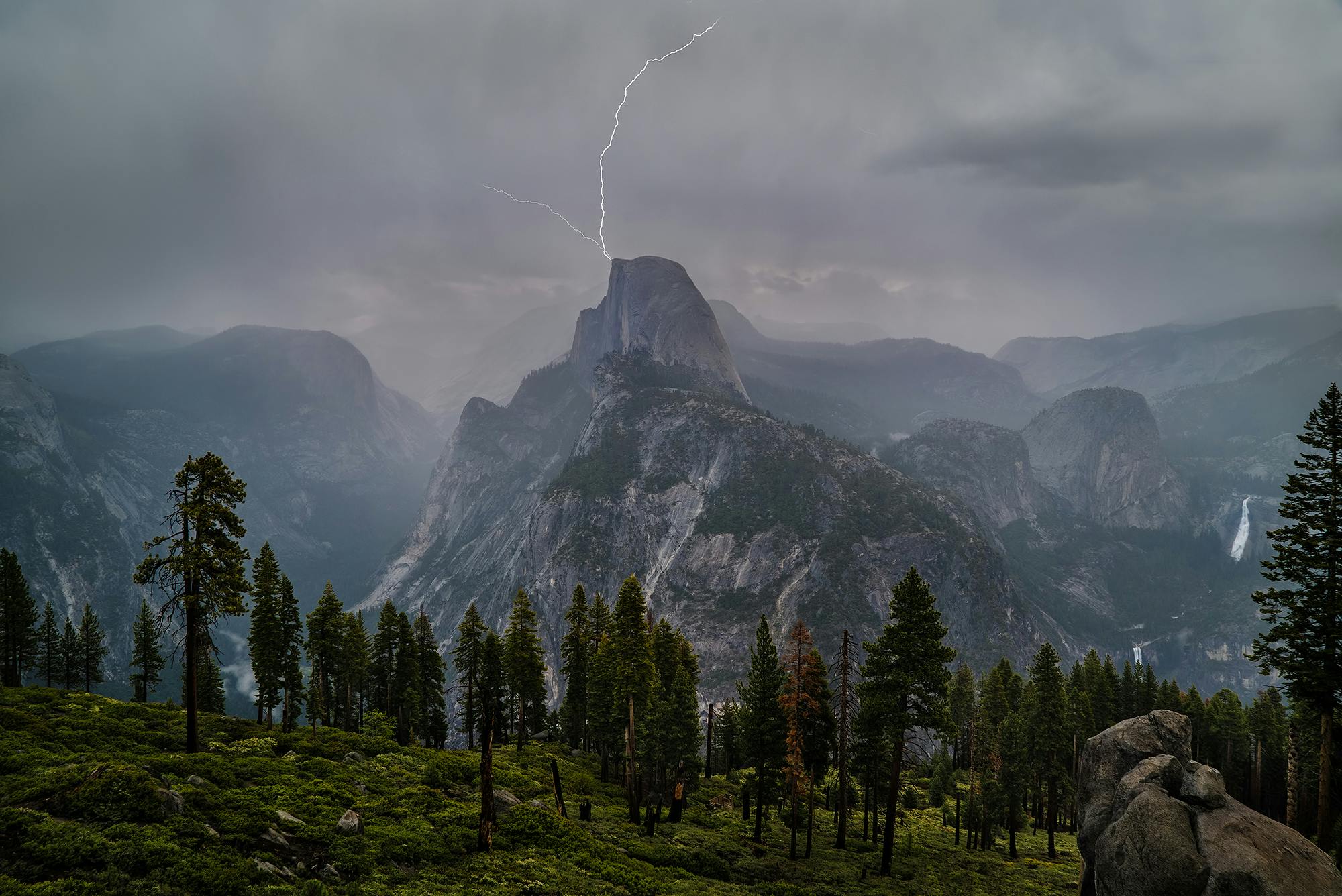Lyn slår ned i fjellet Half Dome i Yosemite nasjonalpark i California