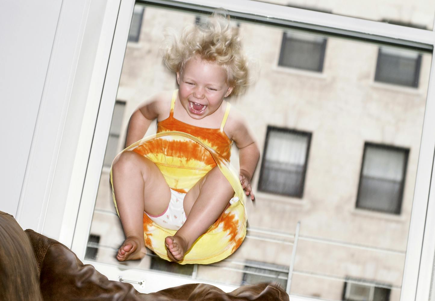Child jumping on sofa