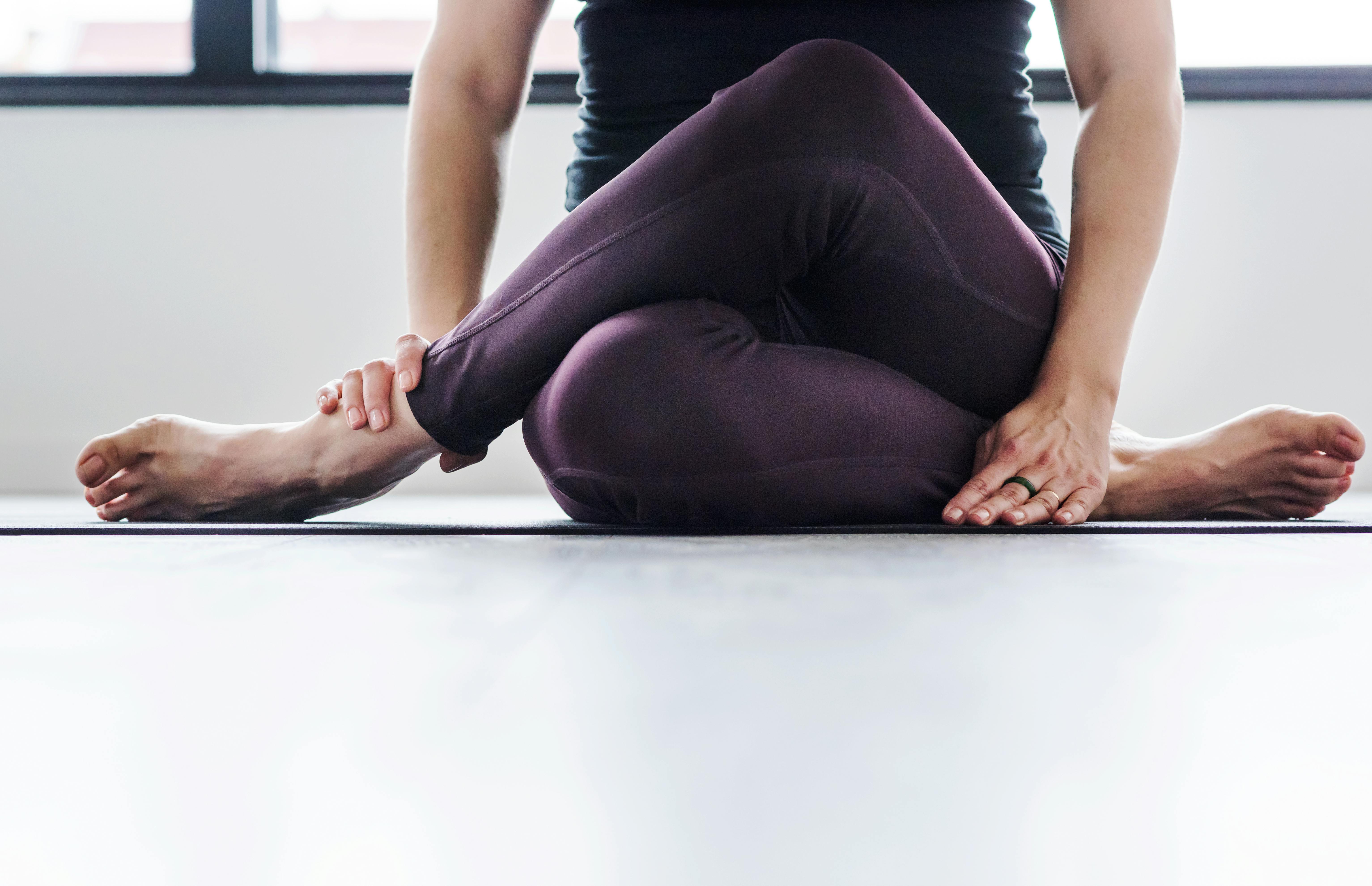 Både hormonyoga og afspænding er træningstricks, du kan ty til. Kvinde dyrker yoga