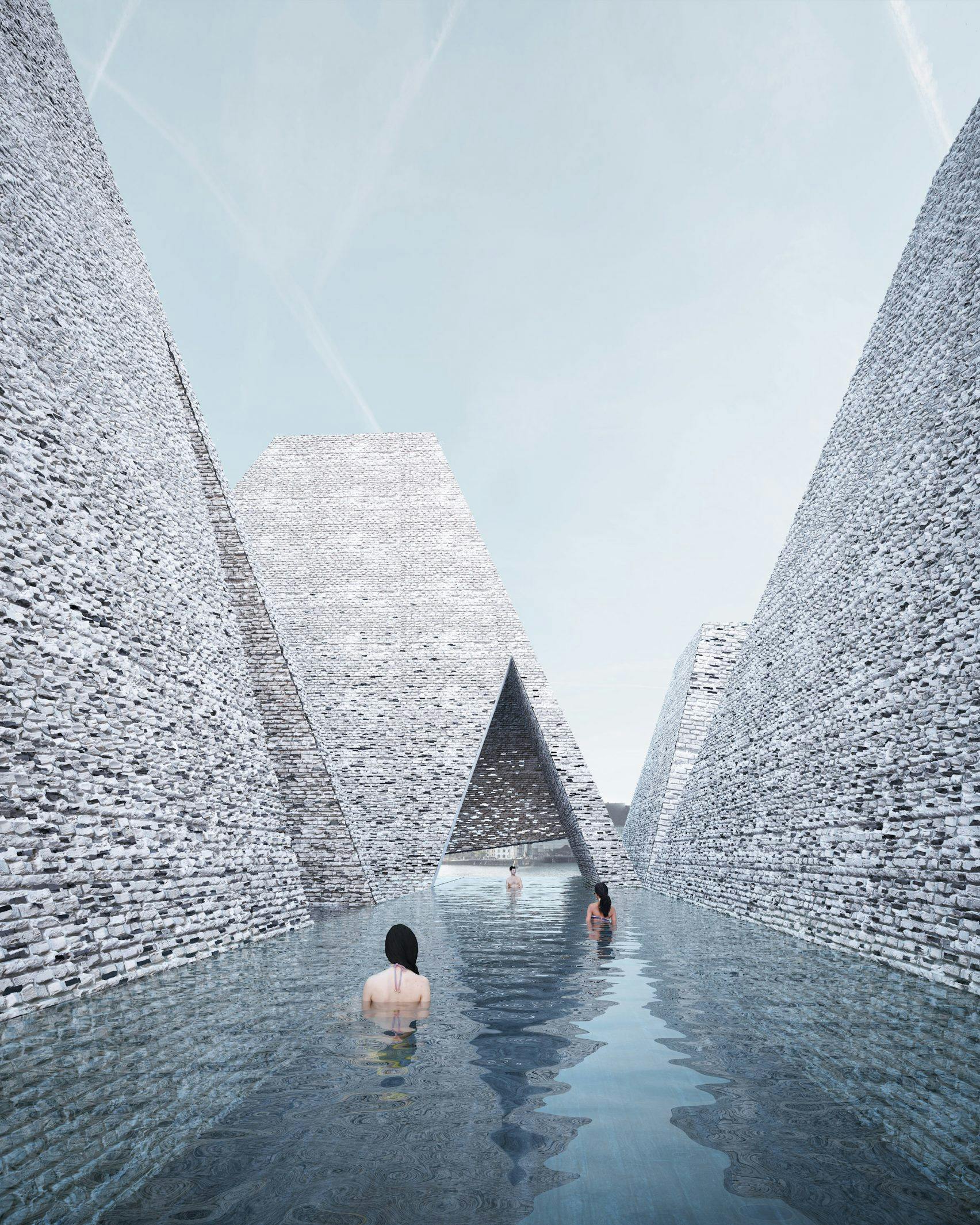 Den udendørs pool bugter sig mellem stenpyramiderne. københavns havnebad pool