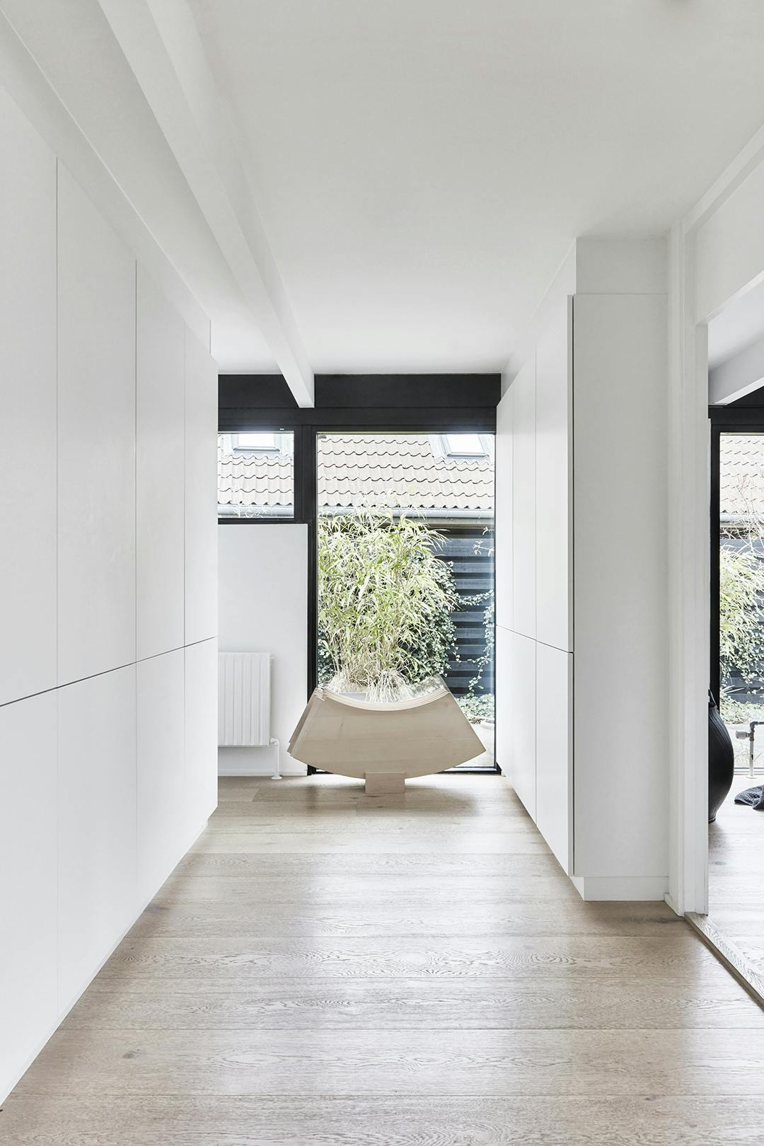 ALLE KASTENWANDEN zijn van Kvik. De sculpturale platen horen bij de PK54-tafel van Poul Kjærholm, die je kunt uitbreiden als er veel gasten zijn. Minimalistisch witte wandkasten.