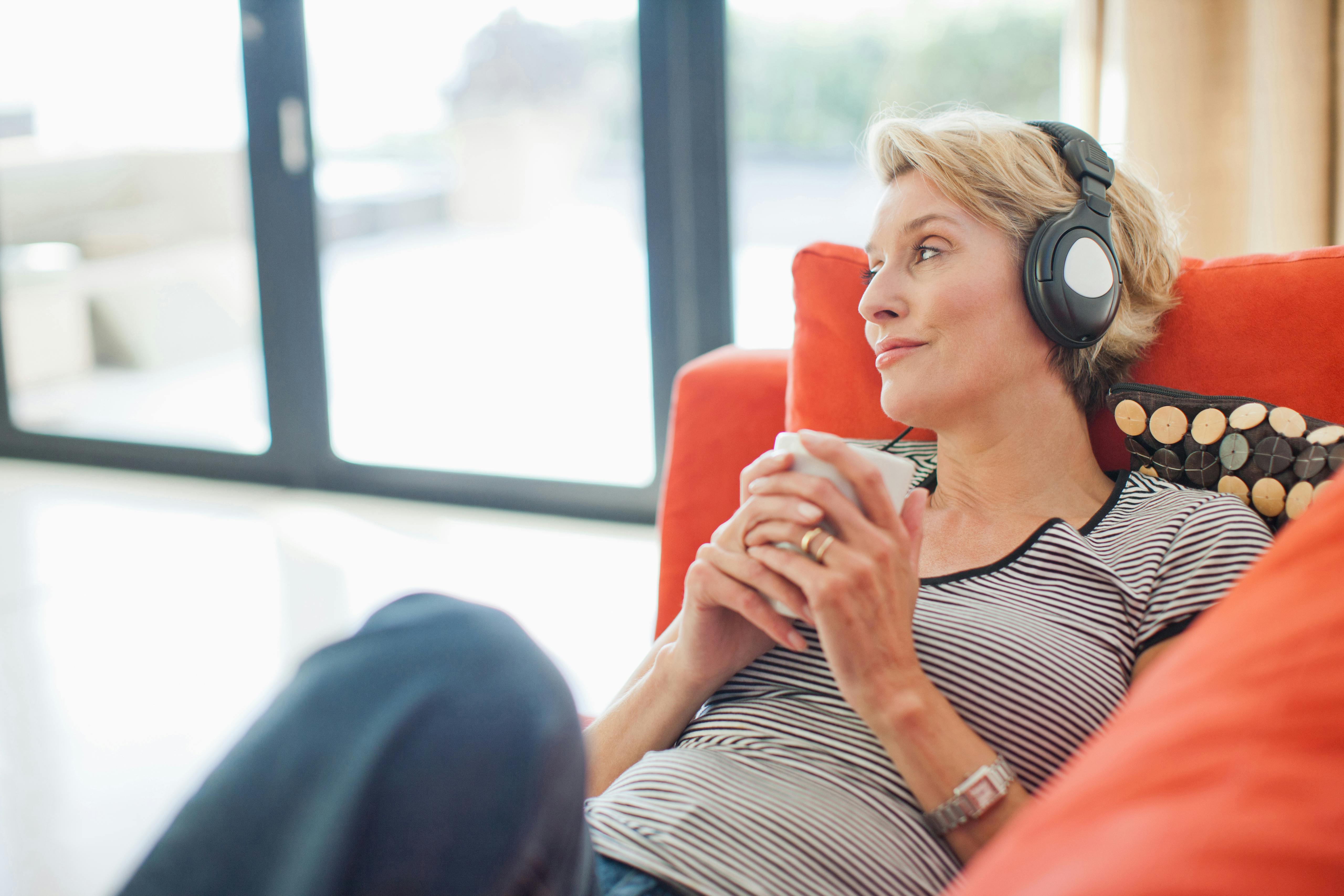 Sæt noget afspændingsmusik på og dæmp dine smerter. Kvinde lytter til musik i høretelefoner