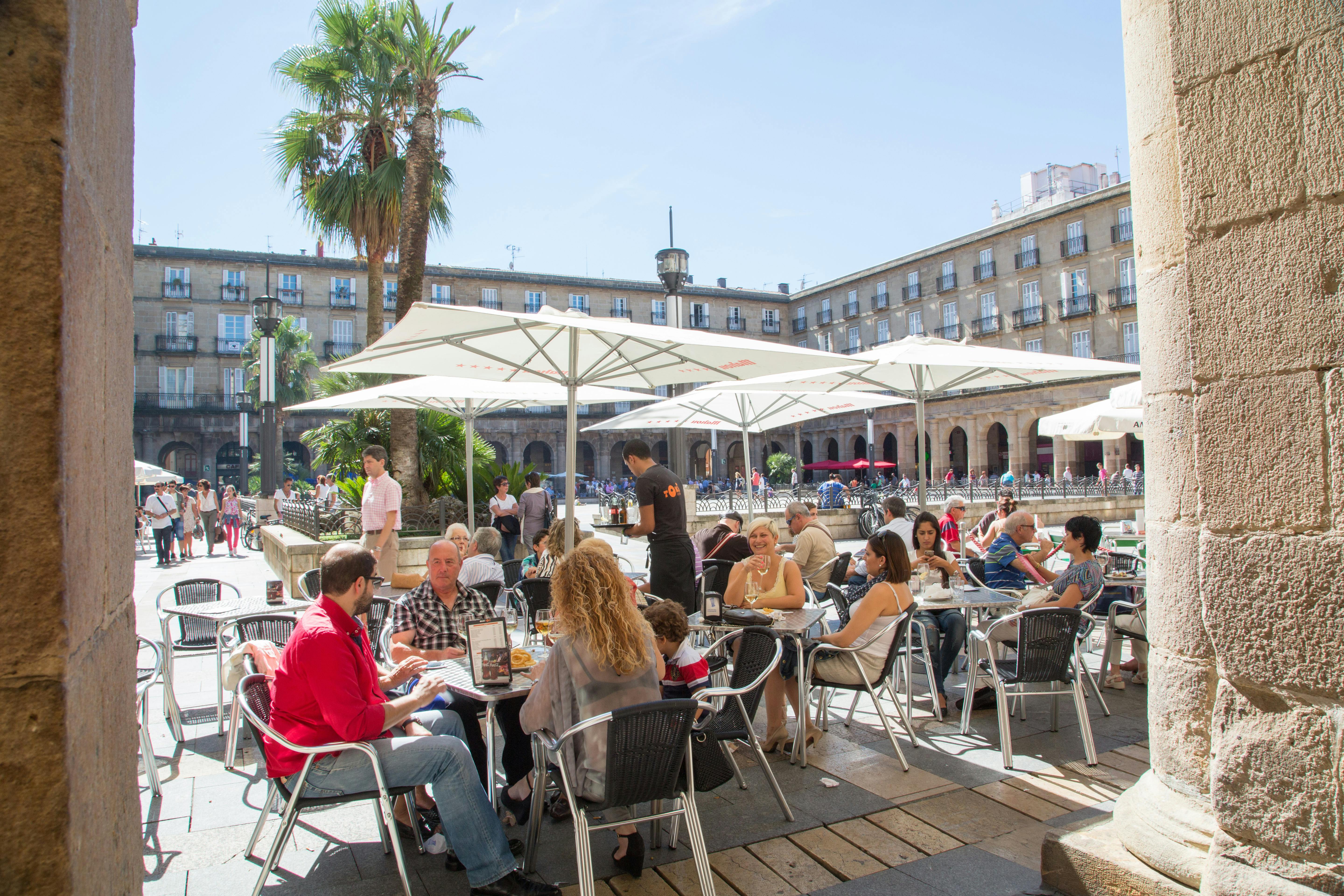 Aaah ja .... Pinxtos og cava i skyggen på Plaza Nueva i Bilbao. Restaurantbillede til rejseguide til Bilbao.